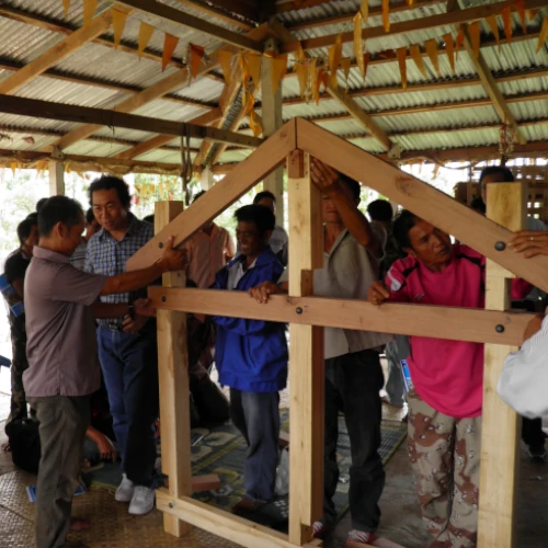 People in southern Lao PDR assemble a wooden house frame